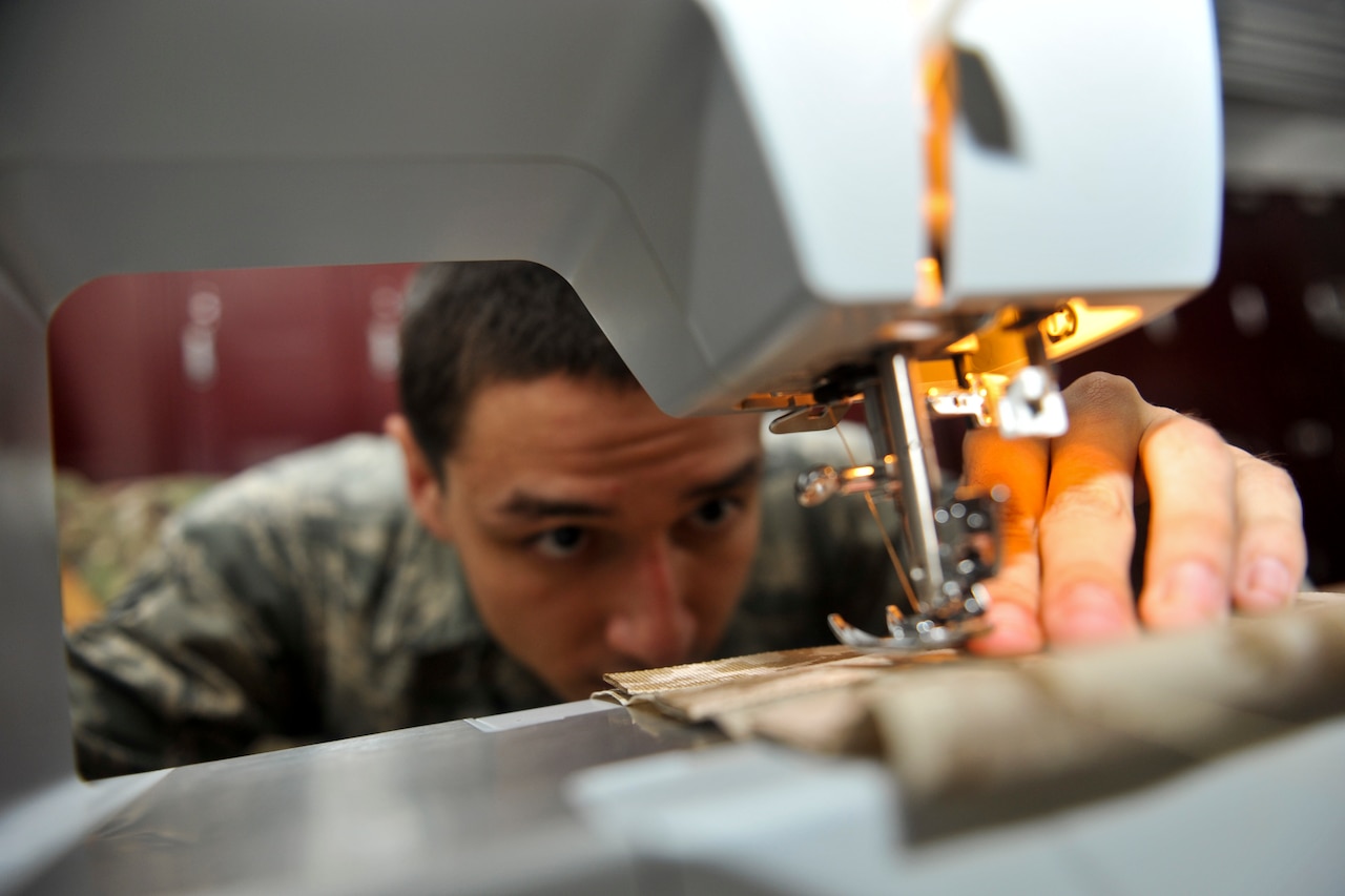 Air Force Senior Airman Devin Litton uses a sewing machine at McConnell Air Force Base, Kan., July 18, 2014. As an aircrew flight equipment journeyman, Litton must apply his sewing skills to repair life rafts and other emergency equipment. U.S. Air Force photo by Airman 1st Class John Linzmeier