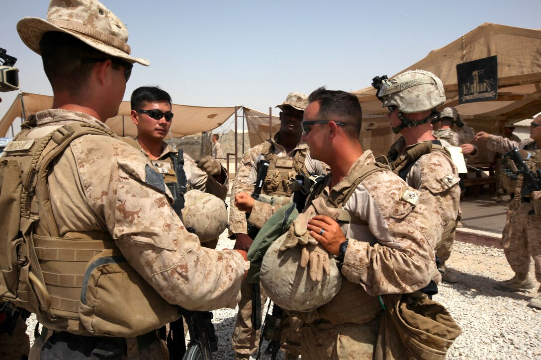 U.S. Marines receive a mission brief and motivate each other before conducting a combat logistics patrol on Camp Leatherneck in Afghanistan's Helmand province, July 14, 2014.