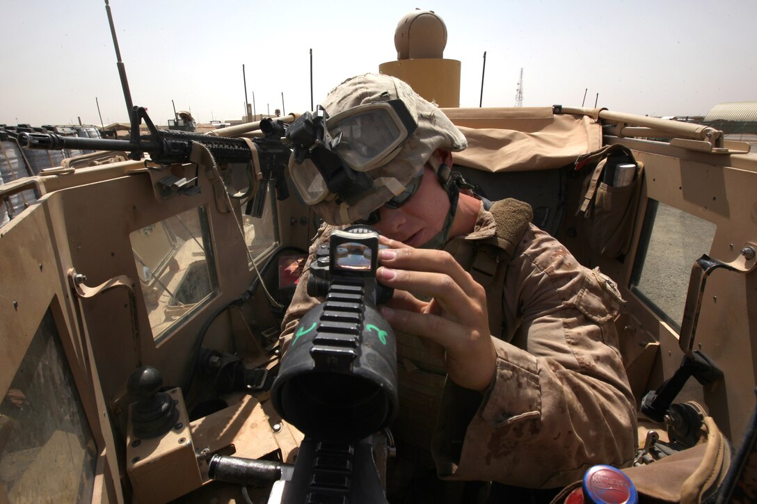 U.S. Marine Corps Cpl. Alex Roberts makes final adjustments to his M240B machine gun in the turret of his mine-resistant, ambush-protected vehicle before conducting a combat logistics patrol on Camp Leatherneck in Afghanistan's Helmand province, July 14, 2014. Roberts, a turret gunner and weapons noncommissioned officer, is assigned to Combat Logistics Battalion 7.