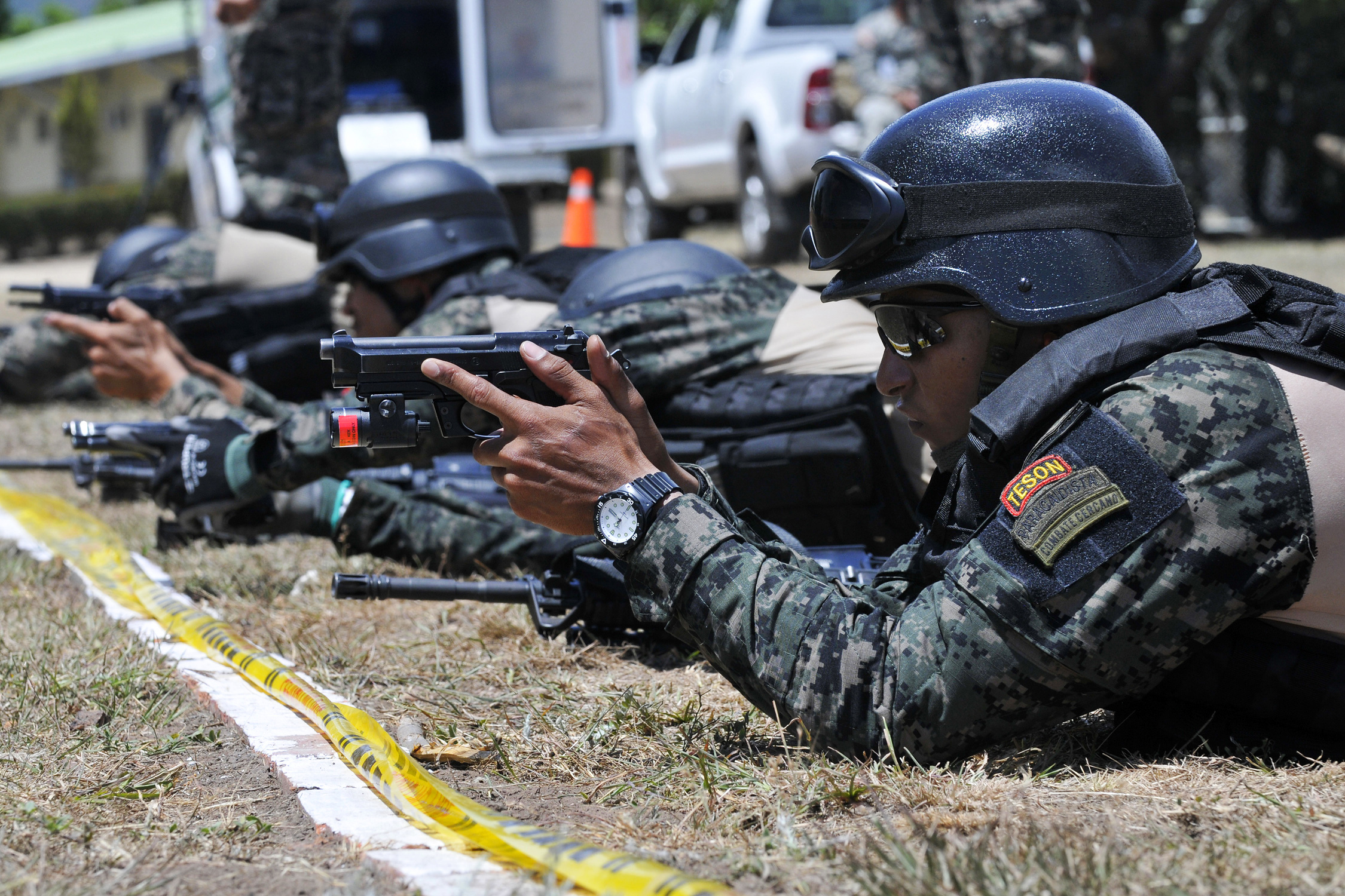 Honduran special operations team members take aim with their pistols