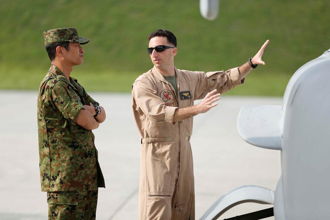 U.S. Marine Corps Capt. David Goodman, aircraft commander with Marine Medium Tiltrotor Squadron 265, Marine Aircraft Group 36, 1st Marine Aircraft Wing, III Marine Expeditionary Force, explains the different functions of the MV22 Osprey to Japanese Ground Self-Defense Force Col. Aso Tatsunobu, Camp Takigahara camp commander, on the Combined Arms Training Center Camp Fuji, Japan, July 15, 2014. The Marines' mission while in the Combined Arms Training Center Camp Fuji was to determine the possibility of future landing zones for the MV22 Osprey. 
(U.S. Marine Corps photo by MCIPAC Combat Camera Lance Cpl. Luis A. Rodriguez III/ Released)
