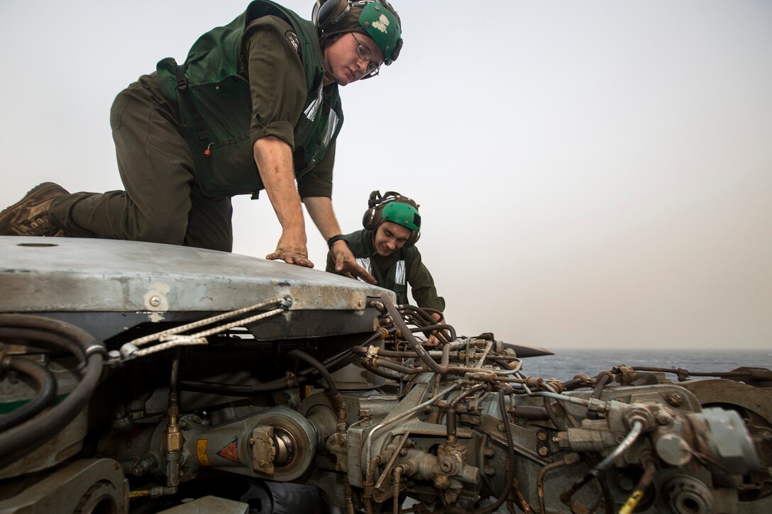 U.S. 5TH FLEET AREA OF RESPONSIBILITY (July 17, 2014) U.S. Marine Corps Cpl. Zachary Yenney, right, Marine Medium Tiltrotor Squadron (VMM) 263 (Reinforced), 22nd Marine Expeditionary Unit (MEU), CH-53E Super Stallion airframe mechanic and native of Freeport, Ill., and Lance Cpl. Thomas Hilton, VMM-263 (Rein.), air frame mechanic and native of Henderson, N.C., perform maintenance on a Super Stallion aboard the amphibious transport dock ship USS Mesa Verde (LPD 19). The 22nd MEU is deployed with the Bataan Amphibious Ready Group as a theater reserve and crisis response force throughout U.S. Central Command and the U.S. 5th Fleet area of responsibility. (U.S. Marine Corps photo by Cpl. Manuel A. Estrada/Released)