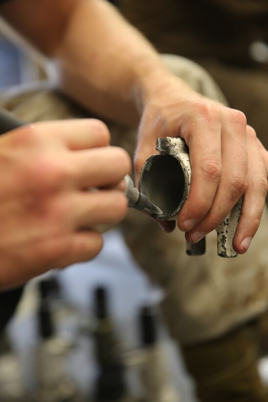 Cpl. Robert Terhune sands the inside of a piece of equipment while fixing and maintaining gear inside the Marine Tactical Electronic Warfare Squadron 2 powerline mechanic shop July 15, 2014. Terhune is a powerline mechanic with VMAQ-2.


