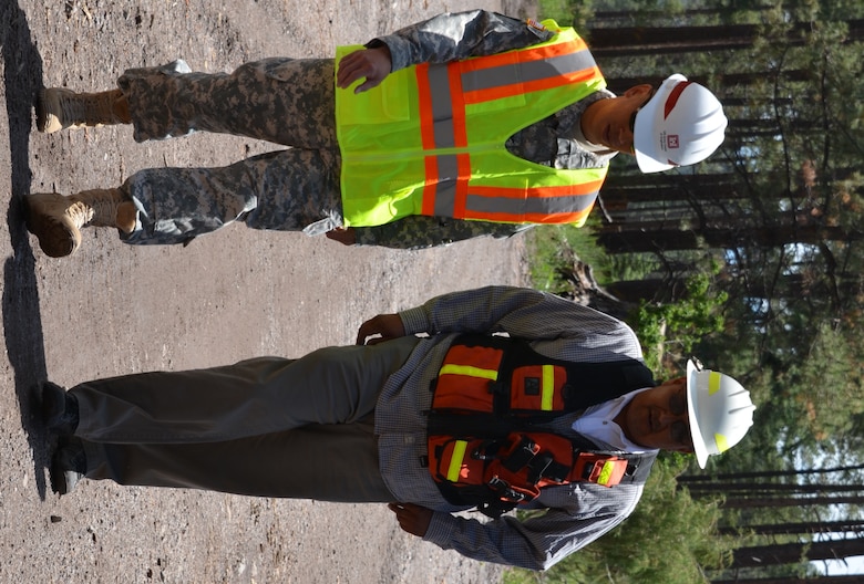 Brig. Gen. Mark Toy, South Pacific Division Commander, left, discusses flood risk management measures and options with Michael Chavarilla, governor, Santa Clara Pueblo, while visiting the Santa Clara burn scar area.