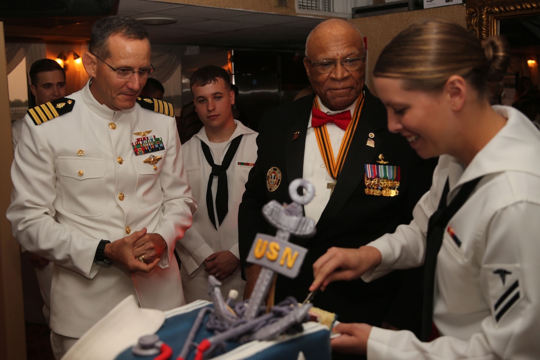 Navy Capt. David A. Lane, Naval Hospital Camp Lejeune commanding officer, retired Maj. James Capers, guest of honor, and the youngest corpsman cut a cake celebrating the 116th birthday of the U.S. Naval Hospital Corps aboard the Henrietta III river boat in Wilmington, N.C., June 14.  (Official U.S. Marine Corps photo by Lance Cpl. Mark Watola/Released)


