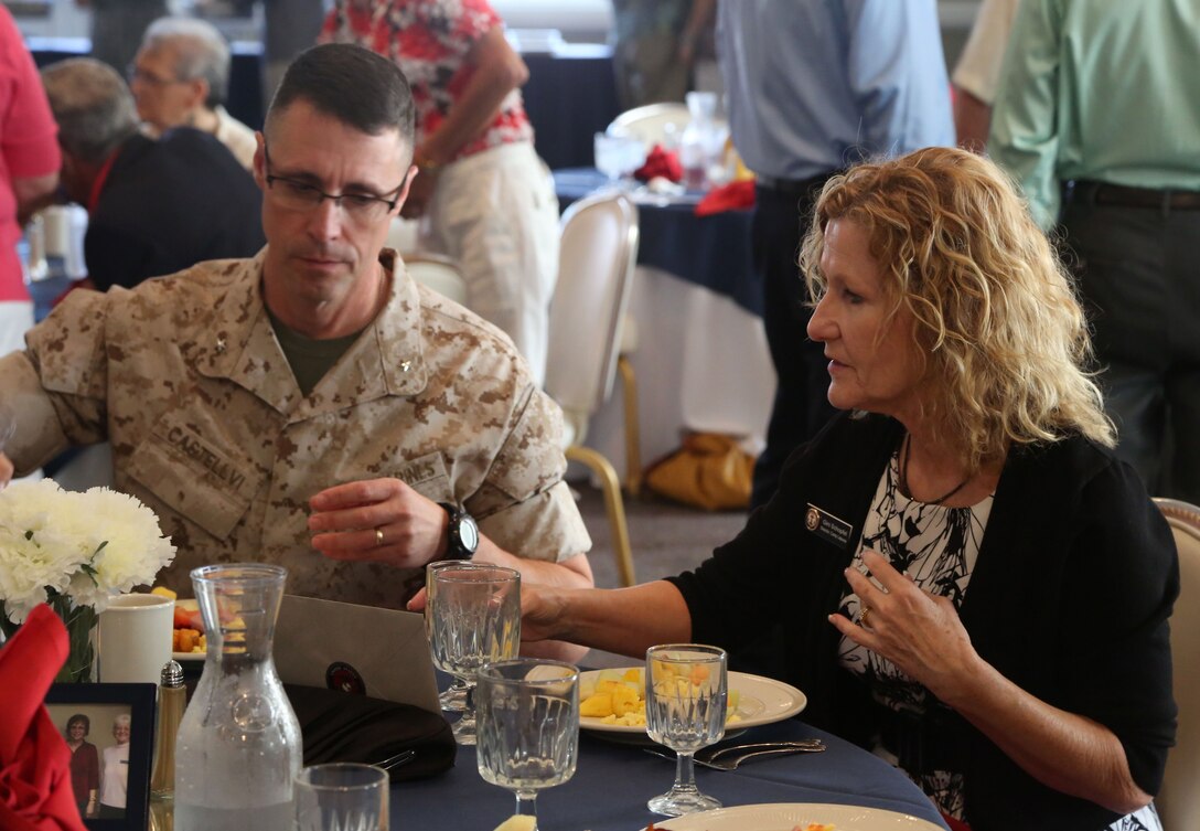 Brig. Gen. Robert F. Castellvi, commanding general of Marine Corps Base Lejeune Installations East, and Gini Schopfel, director of the Lejeune Navy-Marine Corps Relief Society office, eat brunch during Schopfel’s retirement ceremony. Schopfel served 21 years as director of the Lejeune NMCRS office after 20 years in the Marine Corps and retired as a lieutenant colonel. (Official U.S. Marine Corps photo by  Cpl. Jackeline Perez Rivera/Released)