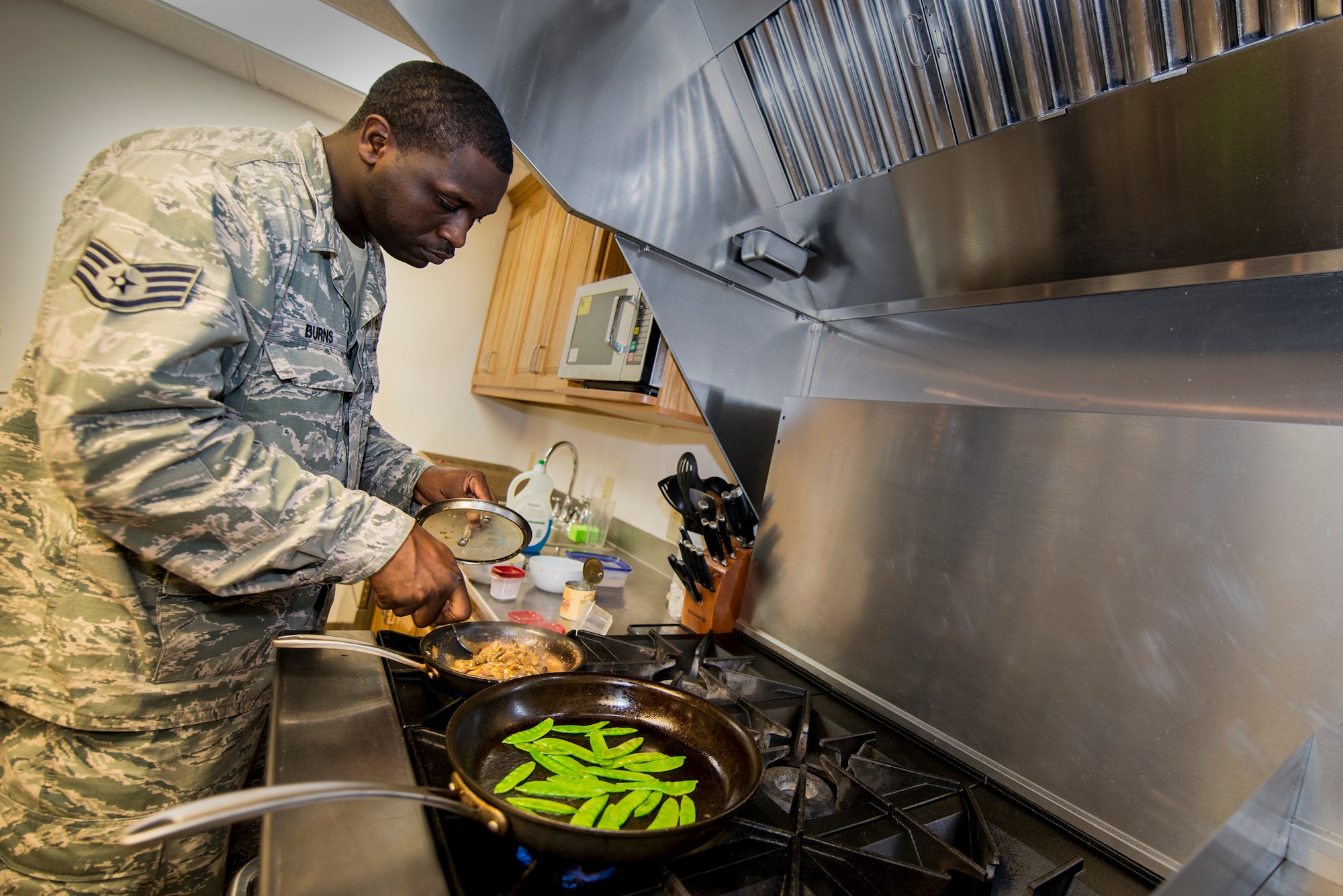 Staff Sgt. Phillip Burns II prepares Monterey chicken July 17, 2014, on Moody Air Force Base, Ga. Burns garnished his plate with sweet peas and mushroom sauce. He is a 23d Civil Engineer Squadron fire inspector. (U.S. Air Force photo/Airman 1st Class Ryan Callaghan)