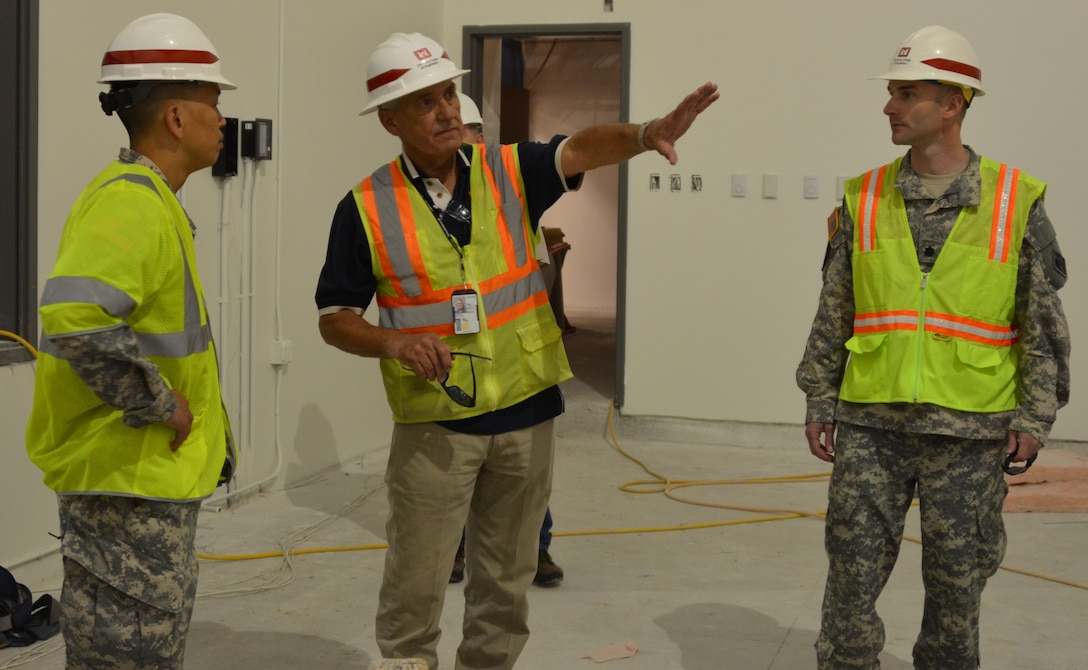 KIRTLAND AIR FORCE BASE, N.M., -- COL (P) Mark Toy, South Pacific Division Commander (left) and LTC Dagon, Albuquerque District Commander (right) receive a briefing from John Wilson, project engineer, Kirtland Resident Office, on the Sustainment Center project at Kirtland Air Force Base. 