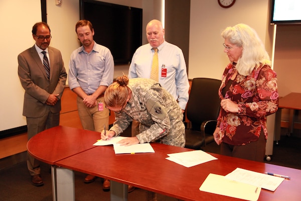 Col. Kim Colloton, commander of the Corps’ Los Angeles District, signs the enabling instrument to establish an In-Lieu Fee program with the Coachella Valley Conservation Commission. The program allows the Coachella Valley Conservation Commission to collect funds from Corps permittees and use the funds for mitigation projects. Participating in the ceremony were (from left) David Castanon, chief of the District’s Regulatory Division; Chris Rea, a UCLA Ph.D. student whose work facilitating meetings, preparing drafts and edits of documents and conducting internal and external coordination was instrumental in the program’s success; Jim Sullivan, the GIS program director for the Coachella Valley Association of Governments, which developed the agreement for the Conservation Commission; and Therese Bradford, chief of the District’s South Coast Regulatory Branch, also participated in the ceremony.