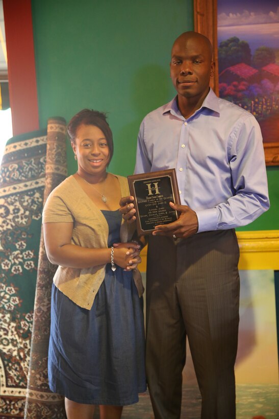 Gunnery Sergeant Otis James and his wife Lytasha hold a plaque honoring them as the Havelock Military Affairs Committee Family of the Quarter following a ceremonial dinner at El Cerro Mexican Bar and Grill in Havelock, N.C., July 22, 2014. James and his wife received the award for dedicating themselves to better the Havelock community. James is currently serving as the company gunnery sergeant and operations chief with Combat Logistics Company 21 at Marine Corps Air Station Cherry Point, while Lytasha works as a stay-at-home mother and full-time college student.


