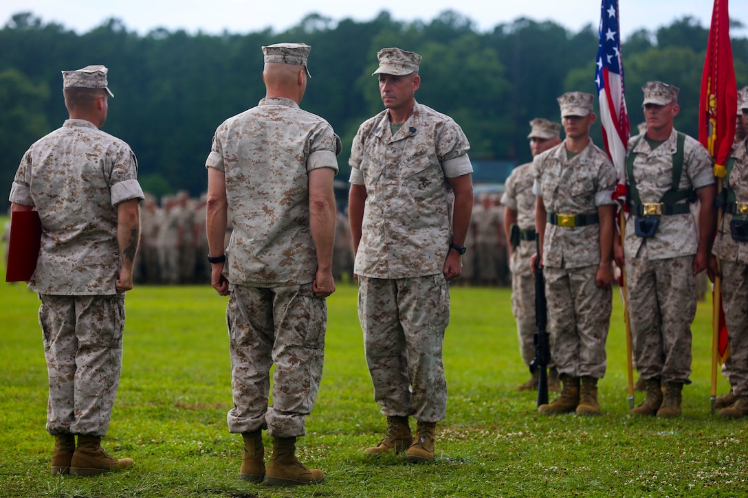Sgt. Maj. Scott L. Theakston, outgoing sergeant major, stands at attention facing the retiring official during the School of Infantry - East relief and appointment ceremony and retirement ceremony at Camp Geiger aboard Marine Corps Base Camp Lejeune, June 27. (Official U.S. Marine Corps photo by Lance Cpl. Jared Lingafelt)


