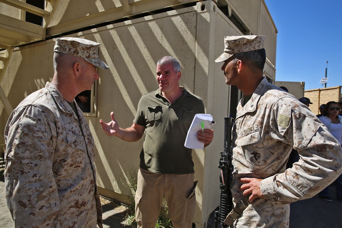 Erik Doman, center, a civil military cooperation representative with the United States Agency for International Development, talks to Col. Erik B. Kraft, left, Headquarters Regiment commanding officer, 1st Marine Logistics Group, and Lt. Col. Wilfred Rivera, right, Combat Logistics Battalion 15 commanding officer, HQ Reg., 1st MLG, during a humanitarian aid exercise as part of CLB-15’s pre-deployment training taught by the Special Operations Training Group, 1st Marine Expeditionary Force, aboard Camp Pendleton, Calif., July 16, 2014. The exercise took place over the course of three days, and provided CLB-15 
with a realistic and immersive experience. The simulation, set up by SOTG with the help of the USAID, put CLB-15’s Marines and sailors in the middle of a typhoon-ravaged rural Philippine area where they were tasked with providing humanitarian aid and disaster relief, similar to the situation faced by 
Marines with the 3rd Marine Expeditionary Force during the aftermath of Typhoon Haiyan in 2013. CLB-15 is slated to deploy with the 15th Marine Expeditionary Unit, 1st Marine Expeditionary Force.