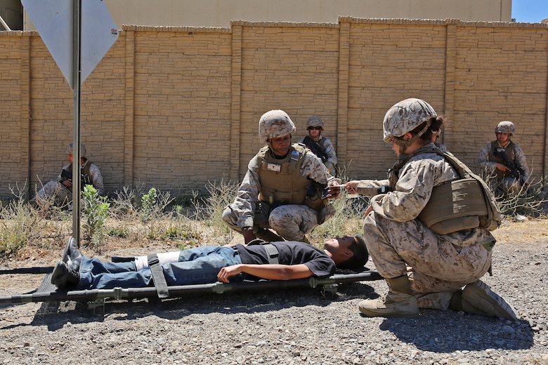 Marines and corpsmen with Combat Logistics Battalion 15, 1st Marine Logistics Group, provide security and prepare a simulated casualty for medical evacuation during a humanitarian aid exercise as part of CLB-15’s pre-deployment training with the Special Operations Training Group, 1st Marine Expeditionary Force, aboard Camp Pendleton, Calif., July 16, 2014. The exercise took place over the course of three days, and provided CLB-15 with a realistic and immersive experience. The simulation, set up by SOTG, put CLB-15’s Marines and sailors in the middle of a typhoon-ravaged rural Philippine area where they were tasked with providing humanitarian aid and disaster relief, similar to the situation faced by Marines with the 3rd Marine Expeditionary Force during the aftermath of Typhoon Haiyan in 2013. CLB-15 is slated to deploy with the 15th Marine Expeditionary Unit, 1st Marine 
Expeditionary Force.