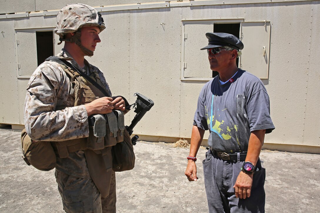 Private First Class Brandon Cleave, left, a motor vehicle operator with Combat Logistics Battalion 15, Headquarters Regiment, 1st Marine Logistics Group, builds rapport with Robert Alvarez Rey Casa, a role-player playing the role of a local government security official, during a humanitarian aid exercise as part of CLB-15’s pre-deployment training with the Special Operations Training Group, 1st Marine Expeditionary Force, aboard Camp Pendleton, Calif., July 
16, 2014. The exercise took place over the course of three days, and provided CLB-15 with a realistic and immersive experience. The simulation, set up by SOTG with the help of the USAID, put CLB-15’s Marines and sailors in the middle of a typhoon-ravaged rural Philippine area where they were tasked with providing humanitarian aid and disaster relief, similar to the situation faced by Marines with the 3rd Marine Expeditionary Force during the aftermath of Typhoon Haiyan in 2013. CLB-15 is slated to deploy with the 15th Marine Expeditionary Unit, 1st Marine Expeditionary Force.