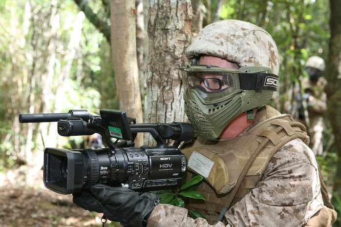 U.S. Marines attached to the combat camera unit with Marine Wing Support Squadron 172, 7th Communication Battalion, III Marine Expeditionary Force, and the provost marshal office conduct combat exercises at the Jungle Warfare Training Center (JWTC) at Camp Gonsalves, Okinawa, Japan, Aug. 20, 2009. JWTC training teaches land navigation, small unit leadership, patrolling and obstacle maneuvering. (U.S. Marine Corps photo by Sgt. Leon M. Branchaud/Released)