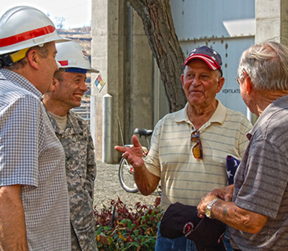 Col. Jose L. Aguilar, commander of the Portland District, and Ron Twiner, Project Manager for The Dalles Lock and Dam operations listen to stories from experiences of former employees, Dean Webster and Aaron Hagaman. 