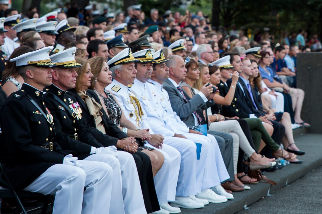Guests watch as Marines from Marine Barracks Washington, D.C., perform during a Tuesday Sunset Parade at the Marine Corps War Memorial in Arlington, Va., July 22, 2014.