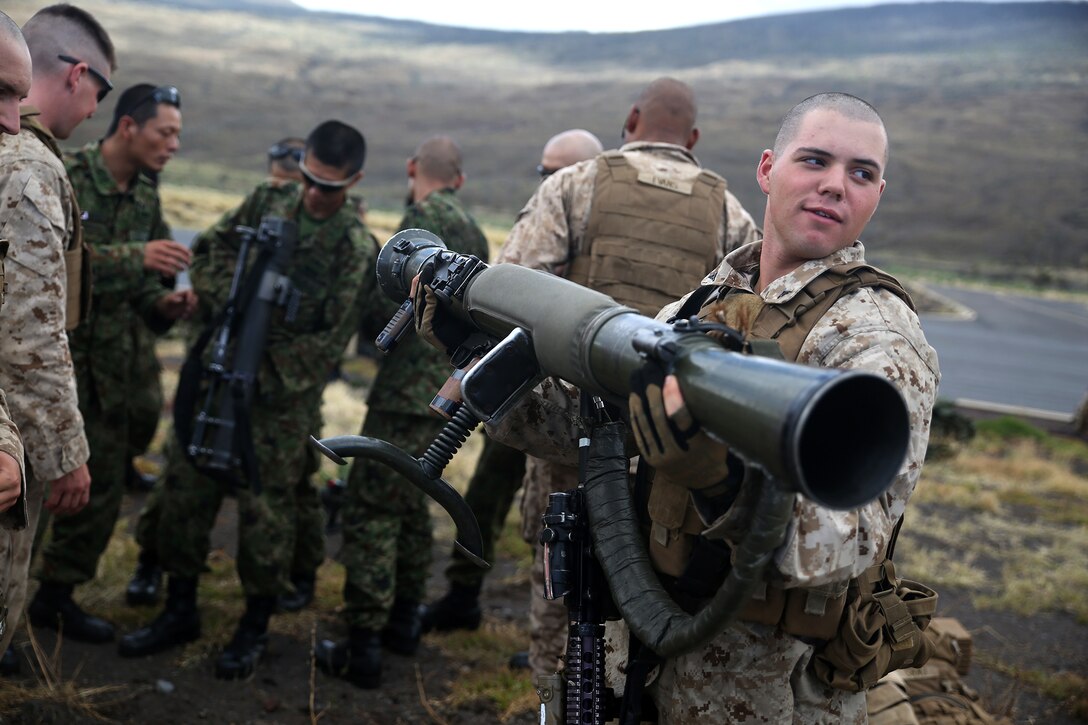 POHAKULOA TRAINING AREA, Hawaii - Lance Cpl. Dylan Morrison, infantryman with India Company, 3rd Battalion, 3rd Marine Regiment, lifts a Japanese Carl Gustav recoilless rifle during Rim of the Pacific (RIMPAC) Exercise 2014 at Pohakuloa Training Area on the Big Island, July 17. The U.S. Marines and Japanese soldiers were viewing each other’s weapons when the groups landed on the island. Twenty-two nations, 49 ships and six submarines, more than 200 aircraft and 25,000 personnel are participating in RIMPAC from June 26 to Aug. 1 in and around the Hawaiian Islands and Southern California. The world's largest international maritime exercise, RIMPAC provides a unique training opportunity that helps participants foster and sustain the cooperative relationships that are critical to ensuring the safety of sea lanes and security on the world's oceans. RIMPAC 2014 is the 24th exercise in the series that began in 1971 (U.S. Marine Corps photo by Sgt. Sarah Dietz/Released)