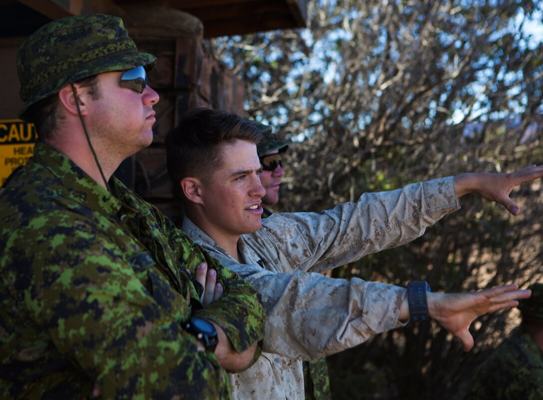 POHAKULOA TRAINING AREA, Hawaii - Cpl. Matthew Nolan, a Seattle native and the training noncommissioned officer with 3rd Battalion, 3rd Marine Regiment, speaks with a Princess Patricia's Canadian Light Infantry soldier about the range terrain prior to a live fire shoot, during the Rim of the Pacific (RIMPAC) Exercise 2014, July 18. Twenty-two nations, more than 40 ships and submarines, about 200 aircraft and 25,000 personnel are participating in RIMPAC from June 26 to Aug. 1 in and around the Hawaiian Islands and Southern California. The world's largest international maritime exercise, RIMPAC provides a unique training opportunity that helps participants foster and sustain the cooperative relationships that are critical to ensuring the safety of sea lanes and security on the world's oceans. RIMPAC 2014 is the 24th exercise in the series that began in 1971. (U.S. Marine Corps photo by Cpl. Erik Estrada/Released)