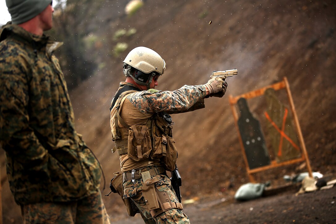 POHAKULOA TRAINING AREA, Hawaii – A U.S. Marine assigned to third  platoon, Alpha Company, 3d Reconnaissance Battalion, draws and fires his M45A1 close quarter battle pistol during lateral movement shooting drills at Range 8, Pohakuloa Training Area, Hawaii, July 19. The recon Marines trained with reconnaissance soldiers from 3rd Battalion, Princess Patricia's Canadian Light Infantry Regiment during Rim of the Pacific (RIMPAC) Exercise 2014. Twenty-two nations, 49 ships and six submarines, more than 200 aircraft and 25,000 personnel are participating in RIMPAC from June 26 to Aug. 1 in and around the Hawaiian Islands and Southern California. The world's largest international maritime exercise, RIMPAC provides a unique training opportunity that helps participants foster and sustain the cooperative relationships that are critical to ensuring the safety of sea lanes and security on the world's oceans. RIMPAC 2014 is the 24th exercise in the series that began in 1971. (U.S. Marine Corps photo by Cpl. Matthew Callahan/Released)