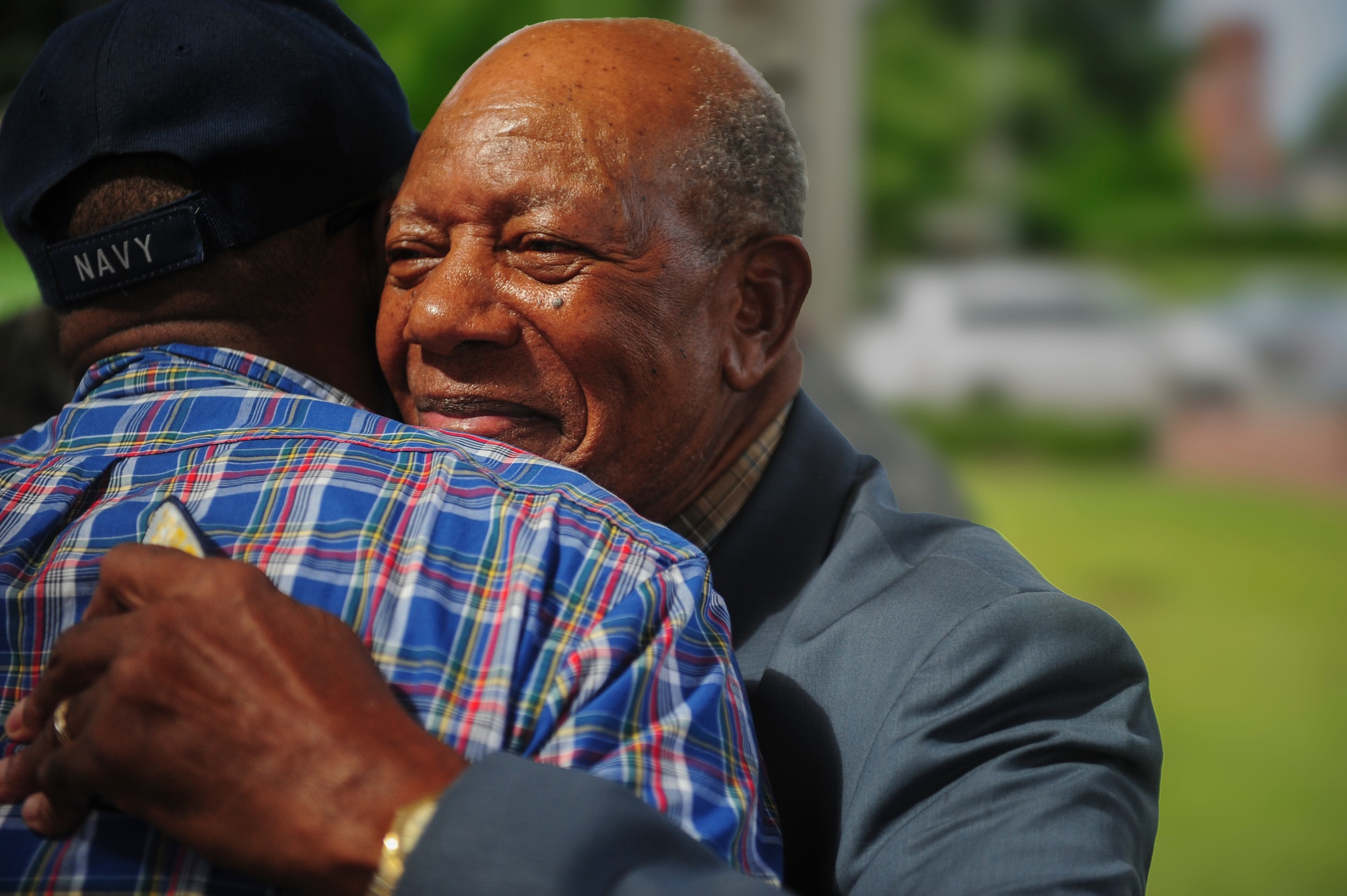 Retired Staff Sgt. Elbert Scott hugs a fellow veteran after a medal presentation ceremony in his honor, July 21, 2014, in downtown Goldsboro, N.C. Scott served at Seymour Johnson Air Force Base with the 4th Supply Squadron until his honorable discharge in 1962. (U.S. Air Force photo/Airman 1st Class Brittain Crolley)