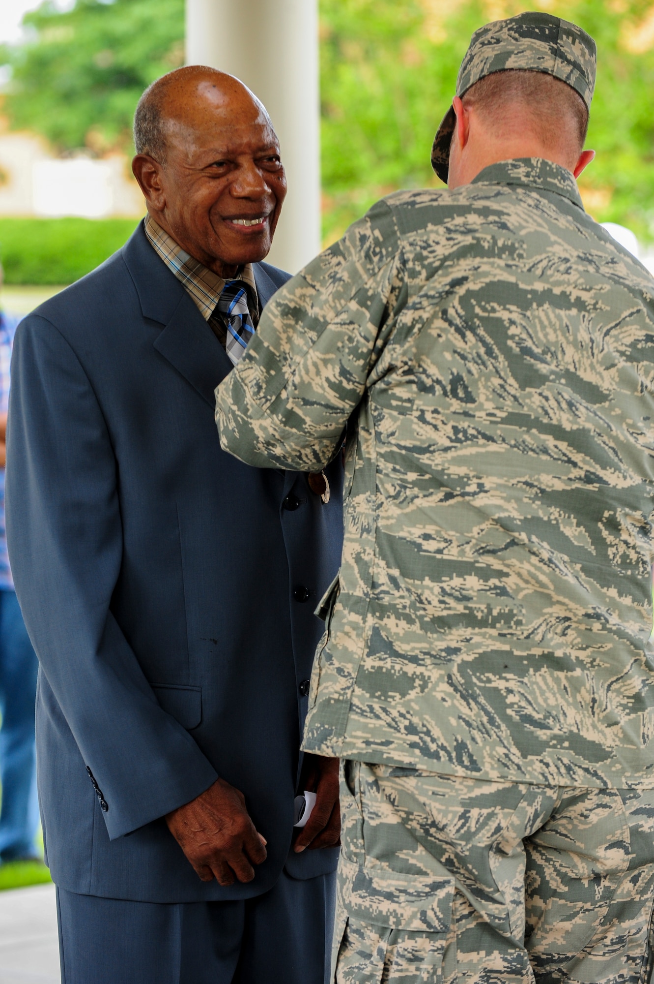 Col. Andrew Bernard pins a medal to retired Staff. Sgt. Elbert Scott during a medal presentation ceremony, July 21, 2014, in Goldsboro, N.C. Scott served in both the U.S. Army and U.S. Air Force from 1945-1966. Bernard is the 4th Fighter Wing vice commander. (U.S. Air Force photo/Airman 1st Class Brittain Crolley)
