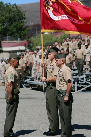 Sergeant Major Mark Arvizu, the Sgt. Maj. of 11th Marine Regiment, passes the regimental colors to Col. Stephen Liszewski, the former commanding officer of 11th Marines, during the regimental change of command ceremony aboard Marine Corps Base Camp Pendleton, Calif., July 22, 2014. Liszewski was also awarded the Legion of Merit during the ceremony. (U.S. Marine Corps photo by Lance Cpl. David Silvano/released)