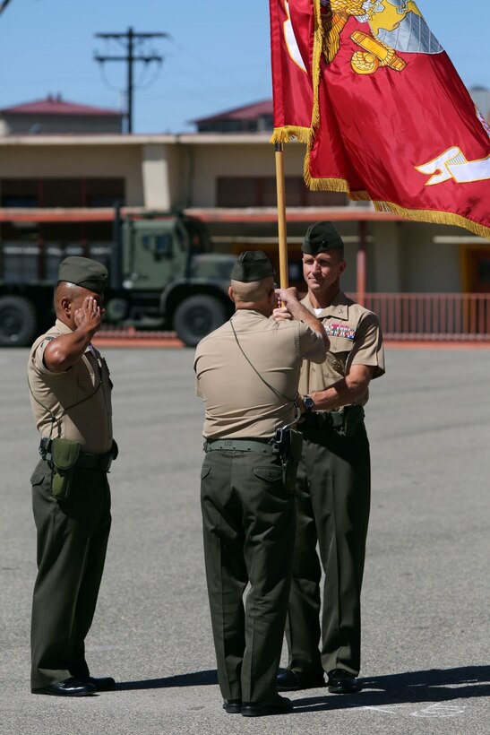 Colonel Stephen Liszewski, the former commanding officer of 11th Marine Regiment, passes the regimental colors to Col. Christopher A. Tavuchis, commanding officer of 11th Marines during the regimental change of command ceremony aboard Marine Corps Base Camp Pendleton, Calif., July 22, 2014. Liszewski was also awarded the Legion of Merit during the ceremony. (U.S. Marine Corps photo by Lance Cpl. David Silvano/released)