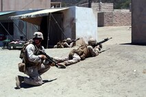 Marines with Company E, 2nd Battalion, 4th Marine Regiment, provide security during a training exercise aboard Marine Corps Base Camp Pendleton, Calif., July 16, 2014. The training was part of a battalion field exercise where Marines continued to improve their urban combat skills with the assistance of the Infantry Immersion Trainer. The IIT provides a training facility for practical application of tactical skills and decision making in an immersive, scenario-based training environment.