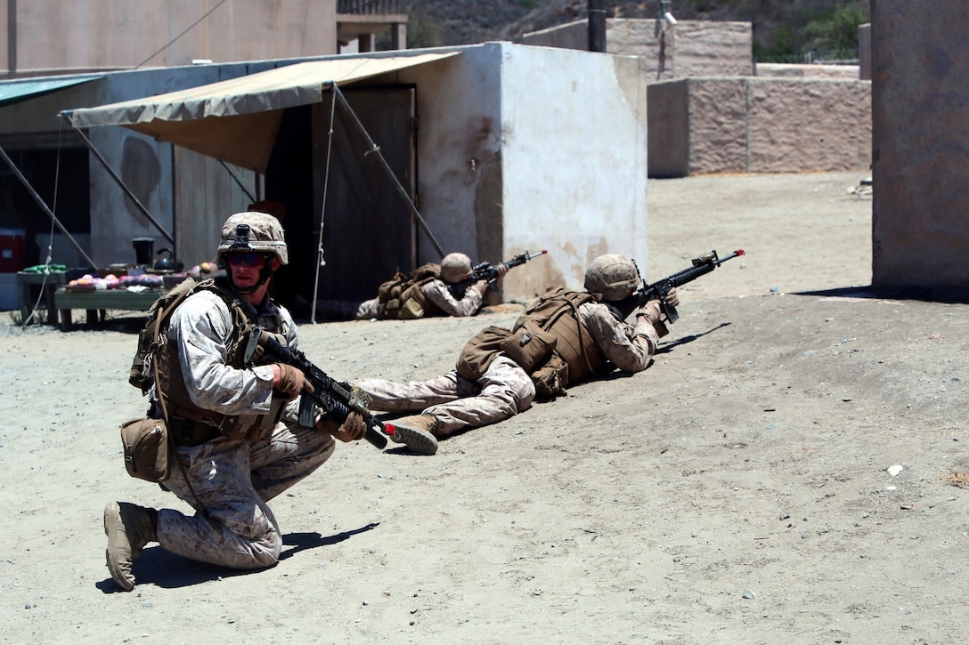 Marines with Company E, 2nd Battalion, 4th Marine Regiment, provide security during a training exercise aboard Marine Corps Base Camp Pendleton, California, July 16, 2014. The training was part of a battalion field exercise where Marines continued to improve their urban combat skills with the assistance of the Infantry Immersion Trainer. The IIT provides a training facility for practical application of tactical skills and decision making in an immersive, scenario-based training environment.