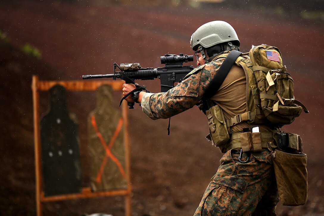 A U.S. Marine assigned to third platoon, Alpha Company, 3d Reconnaissance Battalion, fires rounds from his M4 service rifle during lateral movement shooting on Range 8, Pohakuloa Training Area, Hawaii during Rim of the Pacific Exercise 2014, July 19, 2014. Twenty-two nations, 49 ships and six submarines, more than 200 aircraft and 25,000 personnel are participating in RIMPAC from June 26 to Aug. 1 in and around the Hawaiian Islands and Southern California. The world's largest international maritime exercise, RIMPAC provides a unique training opportunity that helps participants foster and sustain the cooperative relationships that are critical to ensuring the safety of sea lanes and security on the world's oceans. RIMPAC 2014 is the 24th exercise in the series that began in 1971.