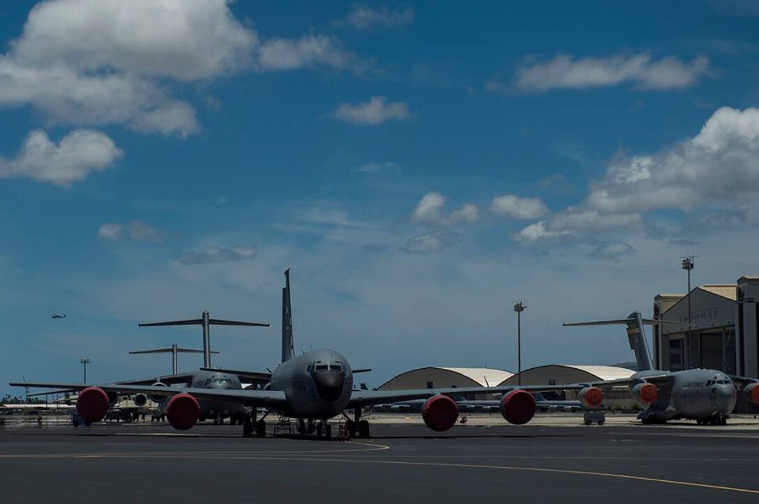 U.S. Air Force aircraft are parked at Hickam Field during the Rim of the Pacific (RIMPAC) exercise July 12, 2014 in Hawaii. Twenty-two nations, more than 40 ships, six submarines, and more than 200 aircraft and 25,000 personnel will participate in the biennial RIMPAC exercise 2014 scheduled June 26 to Aug. 1, in and around the Hawaiian Islands and Southern California. The world's largest international maritime exercise, RIMPAC provides a unique training opportunity that helps participants foster and sustain cooperative relationships that are critical to ensuring the safety of sea lanes and security on the world's oceans. RIMPAC 2014 is the 24th exercise in the series that began in 1971. (U.S. Air Force photo by Senior Airman James Richardson)