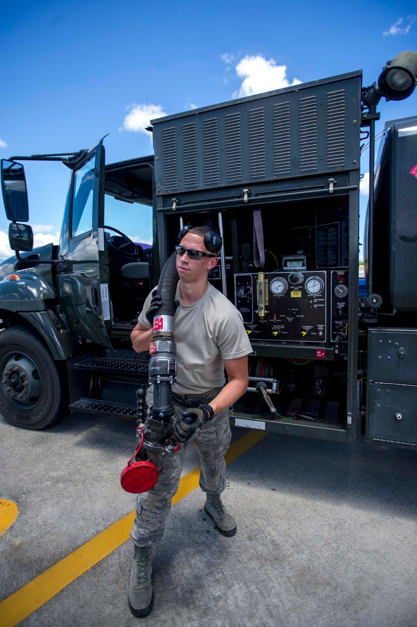 Senior Airman Trevor Kuhns, 18th Logistics Readiness Squadron fuels specialist, prepares to refuel an aircraft on the flightline at Joint Base Pearl Harbor-Hickam, Hawaii, July 18, 2014. Kuhns is deployed from Kadena Air Base, Japan, in support of Rim of the Pacific 2014. RIMPAC is a U.S. Pacific Command-hosted biennial multinational maritime exercise designed to foster and sustain international cooperation on the security of the world's oceans. (U.S. Air Force photo by Tech. Sgt. Terri Paden)
