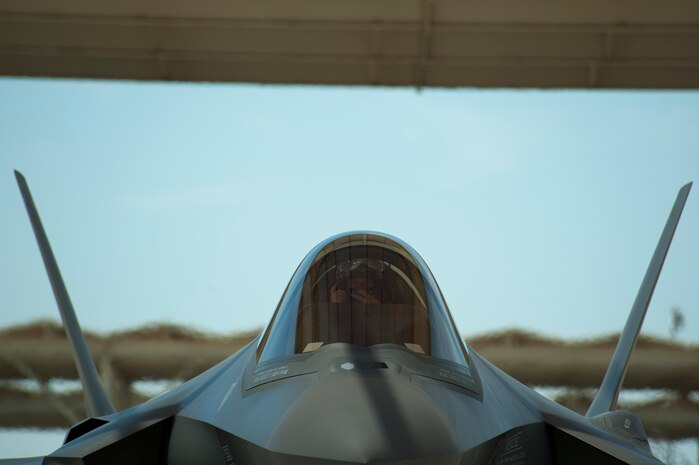 Maj. Joe Scholtz, 59th Test and Evaluation Squadron F-35A Lightning II pilot, adjusts his face mask prior to his flight July 18, 2014, at Nellis Air Force Base, Nev. The F-35’s helmet mounted display system is the most advanced system of its kind. All the intelligence and targeting information an F-35 pilot needs to complete the mission is displayed on the helmet’s visor. (U.S. Air Force photo by Senior Airman Timothy Young)