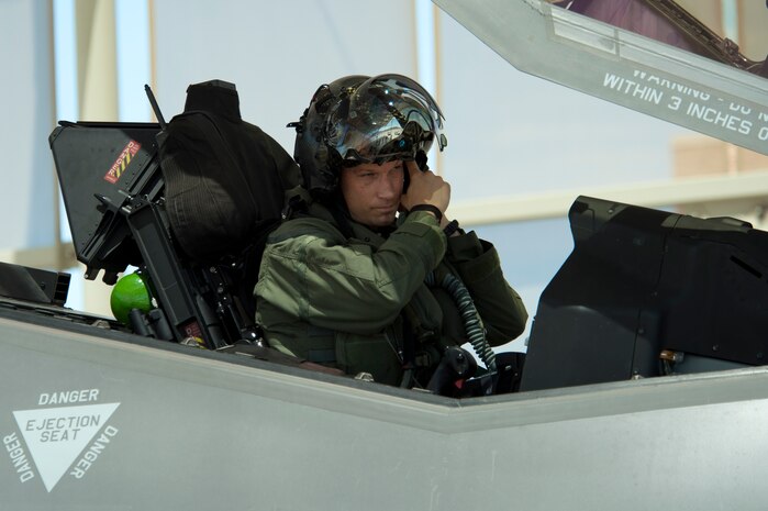 Maj. Joe Scholtz, 59th Test and Evaluation Squadron, F-35A Lightning II pilot, adjusts his helmet prior to flight July 18, 2014, at Nellis Air Force Base, Nev. The F-35’s engine produces 43,000 pounds of thrust and consists of a three-stage fan, a six-stage compressor, an annular combustor, a single stage high-pressure turbine and a two stage low-pressure turbine. (U.S. Air Force photo by Senior Airman Timothy Young)