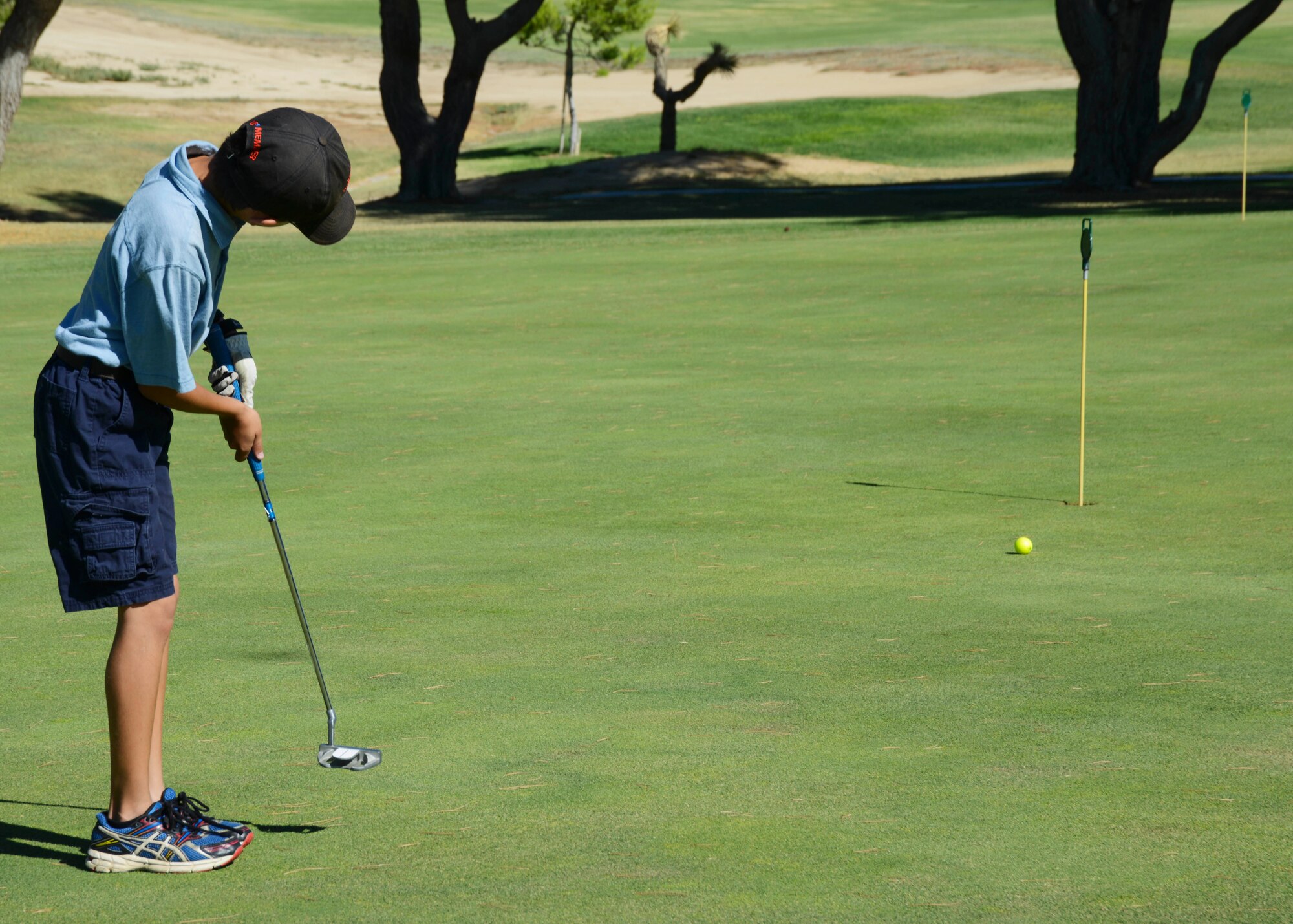 Ten-year-old Noah practices his distance putts for competition. (U.S. Air Force photo by Rebecca Amber) 