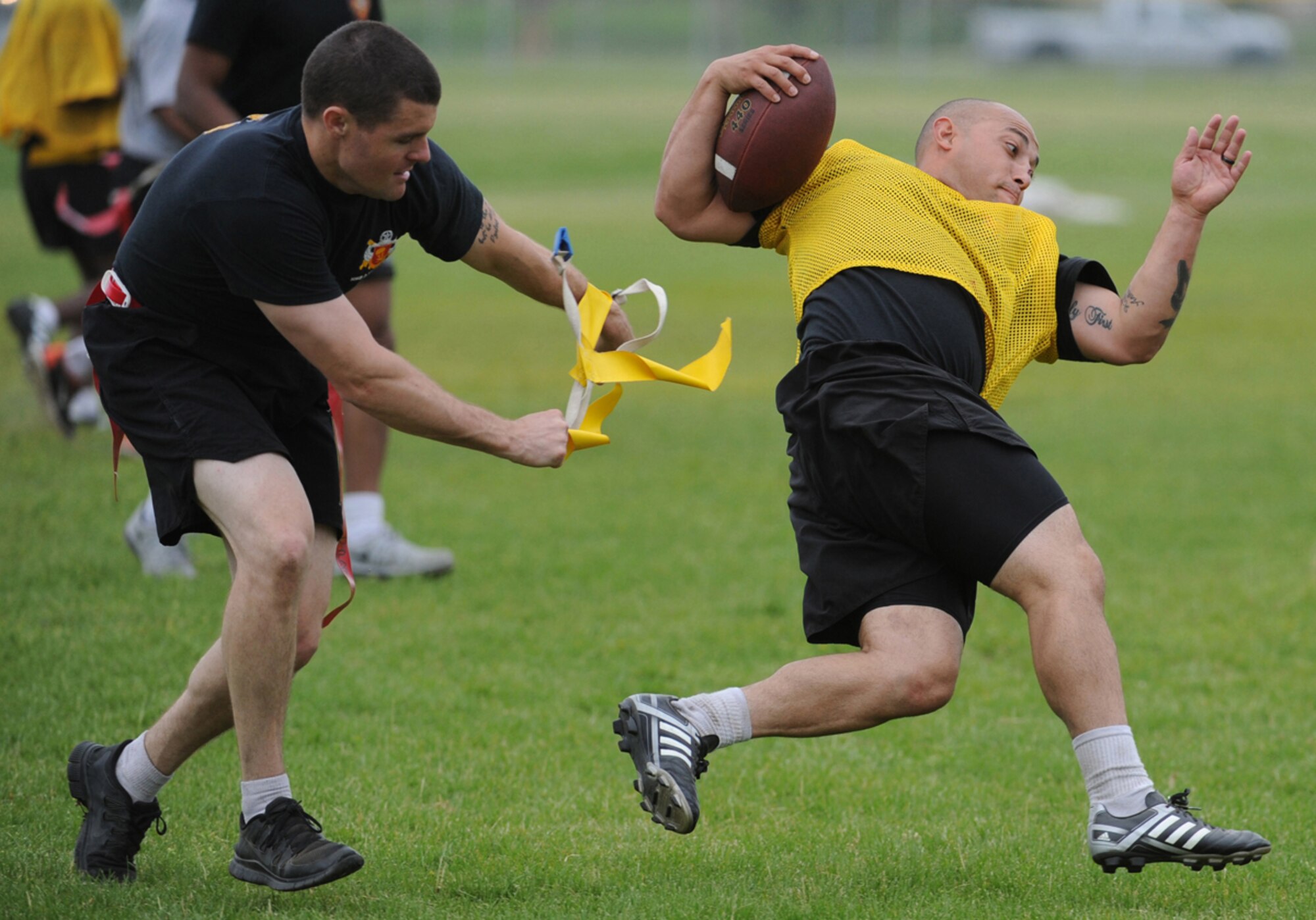 Army Private 1st Class Michael Labre, a native of Manteca, Calif., assigned to the 2nd Battalion, 377th Parachute Field Artillery Regiment, 4th Infantry Brigade Combat Team (Airborne), 25th Infantry Division, U.S. Army Alaska, loses his flags during a flag football game during "Steel Week" festivities on Joint Base Elmendorf-Richardson, Alaska, Thursday, July 17, 2014. "Steel Week" is an organizational week of sporting events culminating in a unit picnic for Soldiers and their dependants. (U.S. Air Force photo/Justin Connaher) 