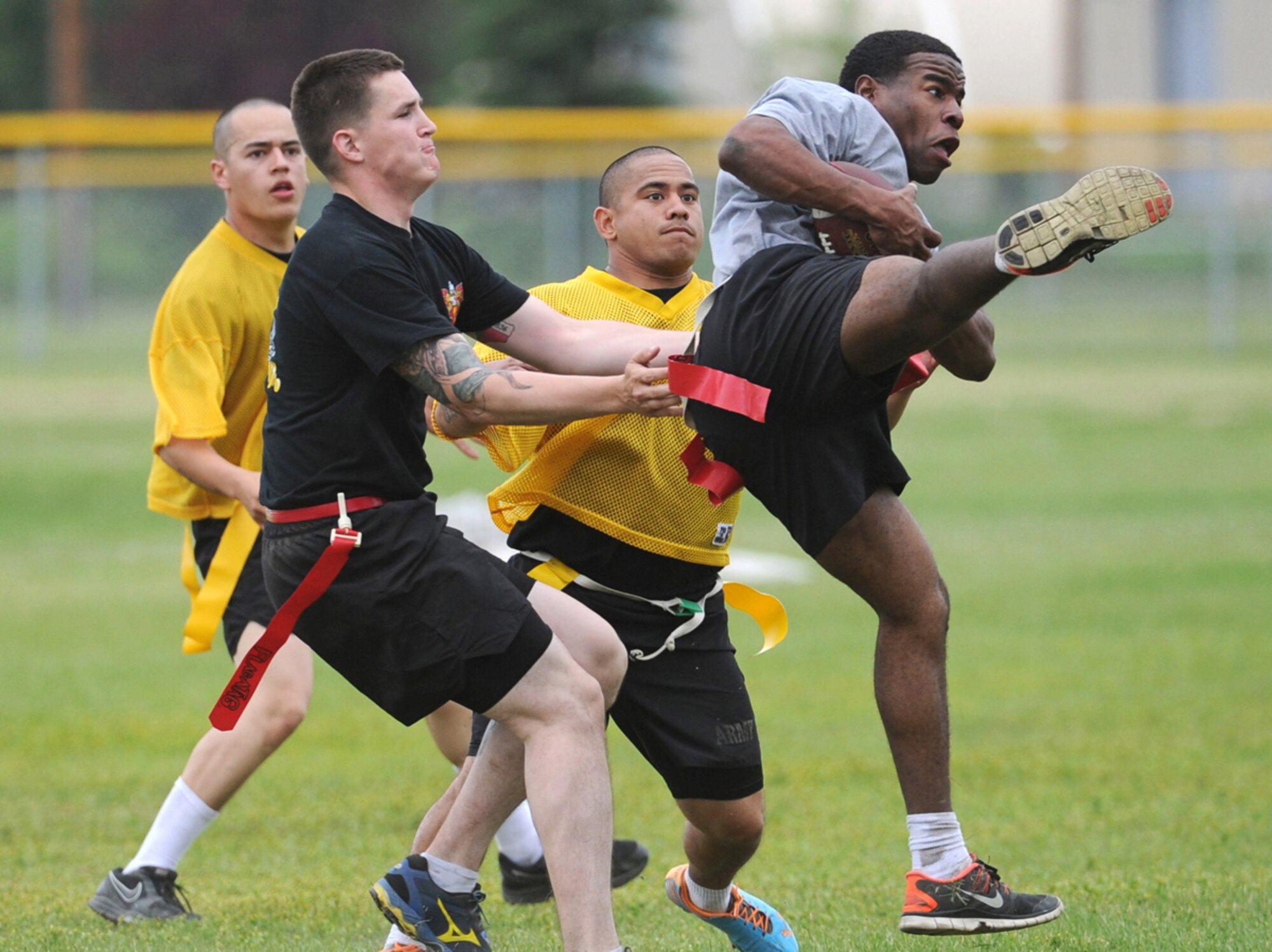 Specialist Christopher Cook, a native of Newnan, Ga., assigned to the 2nd Battalion, 377th Parachute Field Artillery Regiment, 4th Infantry Brigade Combat Team (Airborne), 25th Infantry Division, U.S. Army Alaska,  makes a mid-air catch during a flag football game during "Steel Week" festivities on Joint Base Elmendorf-Richardson, Alaska, Thursday, July 17, 2014. "Steel Week" is an organizational week of sporting events culminating in a unit picnic for Soldiers and their dependants. (U.S. Air Force photo/Justin Connaher) 