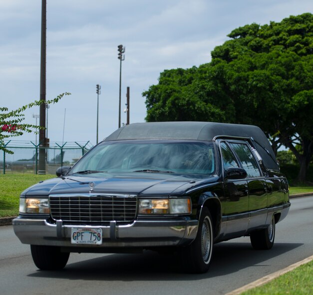 A convoy of vehicles transport the remains of Col. Eugene Smith from the Joint POW/MIA Accounting Command facility on Joint Base Pearl Harbor-Hickam, Hawaii July 22, 2014. While flying to Elmendorf Air Force Base in November 1952, Smith was lost when his Douglas C-124 Globemaster II crashed into the side of Mt. Gannet in Alaska. The lost crash site was recently found by the Alaska Air National Guard. Smith will be brougt home to Delaware via military dignified transfer July 24, 2014 and will recieve a burial with full military honors. (U.S. Air Force photo by Staff Sgt. Nathan Allen/Released)