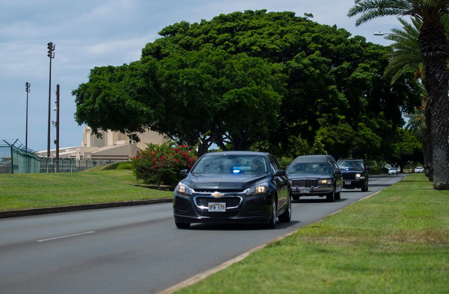 A convoy of vehicles transport the remains of Col. Eugene Smith from the Joint POW/MIA Accounting Command facility on Joint Base Pearl Harbor-Hickam, Hawaii July 22, 2014. While flying to Elmendorf Air Force Base in November 1952, Smith was lost when his Douglas C-124 Globemaster II crashed into the side of Mt. Gannet in Alaska. The lost crash site was recently found by the Alaska Air National Guard. Smith will be brougt home to Delaware via military dignified transfer July 24, 2014 and will recieve a burial with full military honors. (U.S. Air Force photo by Staff Sgt. Nathan Allen/Released)