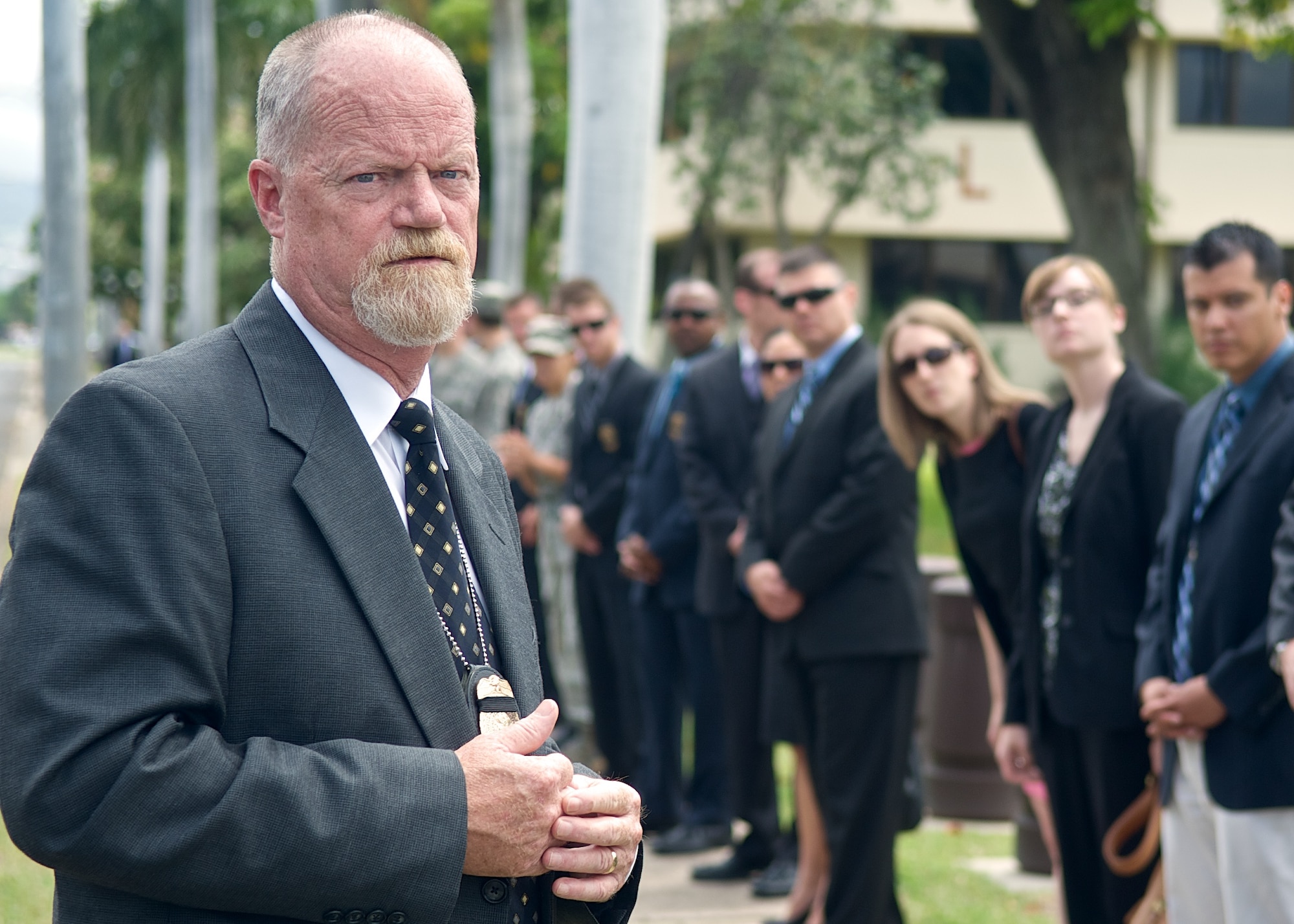 Special Agent Timothy Ries, Office of Special Investigations Region Six deputy director, awaits a convoy of vehicles transporting the remains of Col. Eugene Smith from the Joint POW/MIA Accounting Command facility on Joint Base Pearl Harbor-Hickam, Hawaii July 22, 2014. While flying to Elmendorf Air Force Base in November 1952, Smith was lost when his Douglas C-124 Globemaster II crashed into the side of Mt. Gannet in Alaska. The lost crash site was recently found by the Alaska Air National Guard. Smith will be brought home to Delaware via military dignified transfer July 24, 2014 and will receive a burial with full military honors. (U.S. Air Force photo by Tech. Sgt. James Stewart/Released)