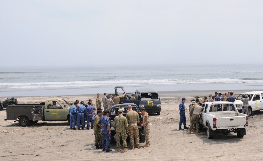 Explosive Ordnance Disposal members from the U.S. Air Force, U.S. Navy and Japanese Maritime Self-Defense Forces analyze their tools and equipment used to wire explosives onto a vehicle at the Draughon Bombing Range, Misawa Air Base, Japan, July 15, 2014. The group separated into different teams to give individuals a more focused, hands-on approach to working with the equipment. (U.S. Air Force photo/Senior Airman Jose L. Hernandez-Domitilo)  