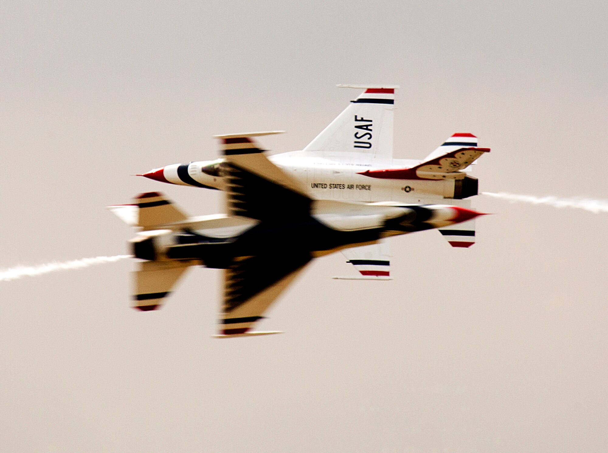 140723-F-JW079-210 Maj. Blaine Jones and Maj. Jason Curtis, U.S. Air Force Thunderbirds pilots, perform the inverted opposing knife edge aerial maneuver July 23 during an air show over Laramie County Community College in Cheyenne, Wyo. Jones and Curtis, lead soloist and opposing soloist respectively, performed a variety of maneuvers. (U.S. Air Force photo by R.J. Oriez)