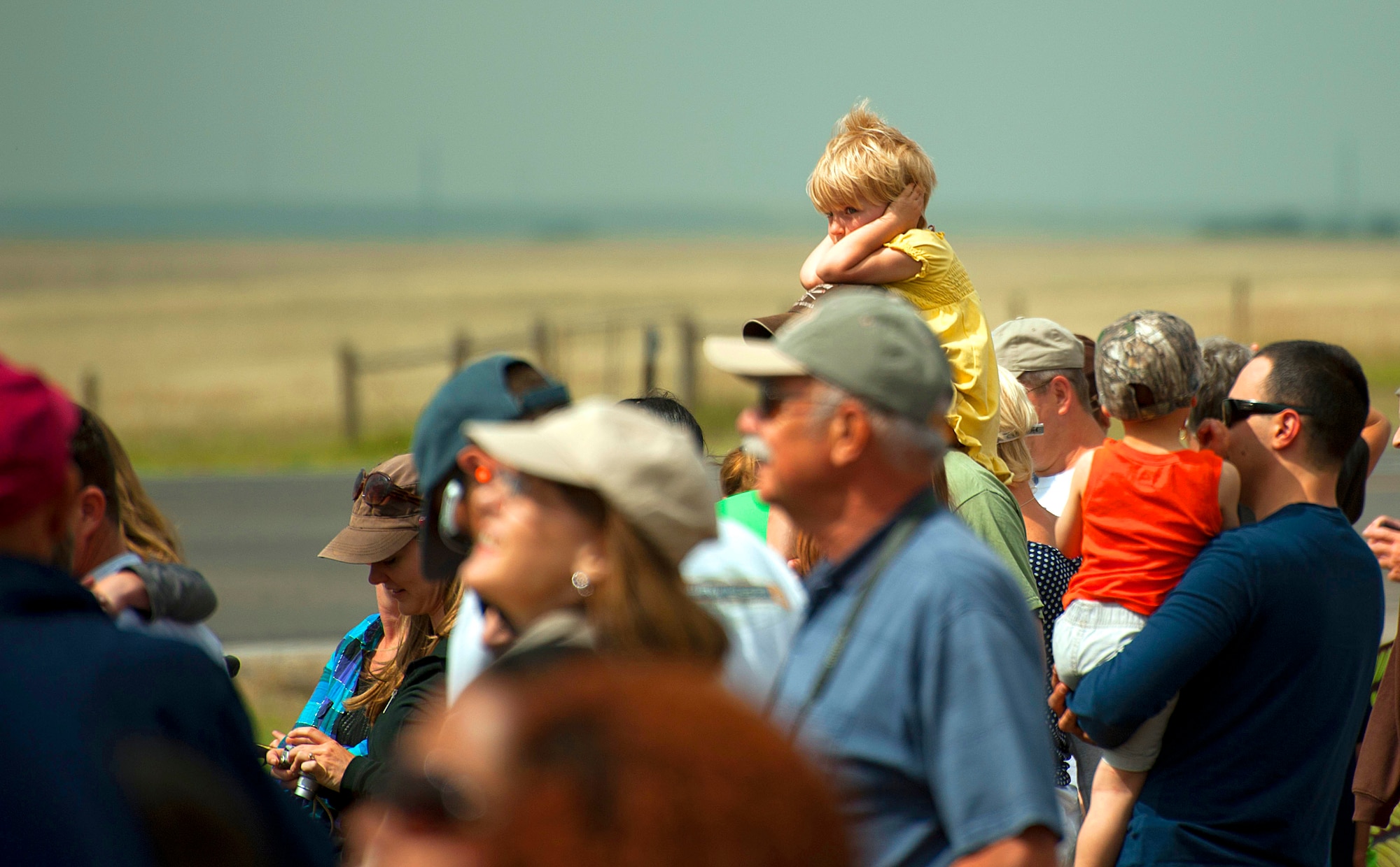 140723-F-GZ967-098 A crowd of people look on as the U.S. Air Force Thunderbirds perform July 23 over the skies of Cheyenne, Wyo. Due to the close proximity the F-16s fly, they can create a loud, thunderous noise. (U.S. Air Force photos by Airman 1st Class Brandon Valle)