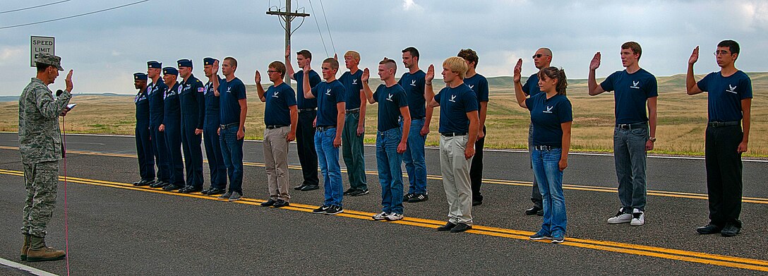 140723-F-GZ967-074 Members of the 367th Recruiting Squadron delayed entry program recite the oath of enlistment during a ceremony at Laramie County Community College July 23. Lt. Gen. Stanley Clarke III, director of the Air National Guard, presided over the ceremony and administered the oath for the DEP recruits to repeat. (U.S. Air Force photos by Airman 1st Class Brandon Valle)