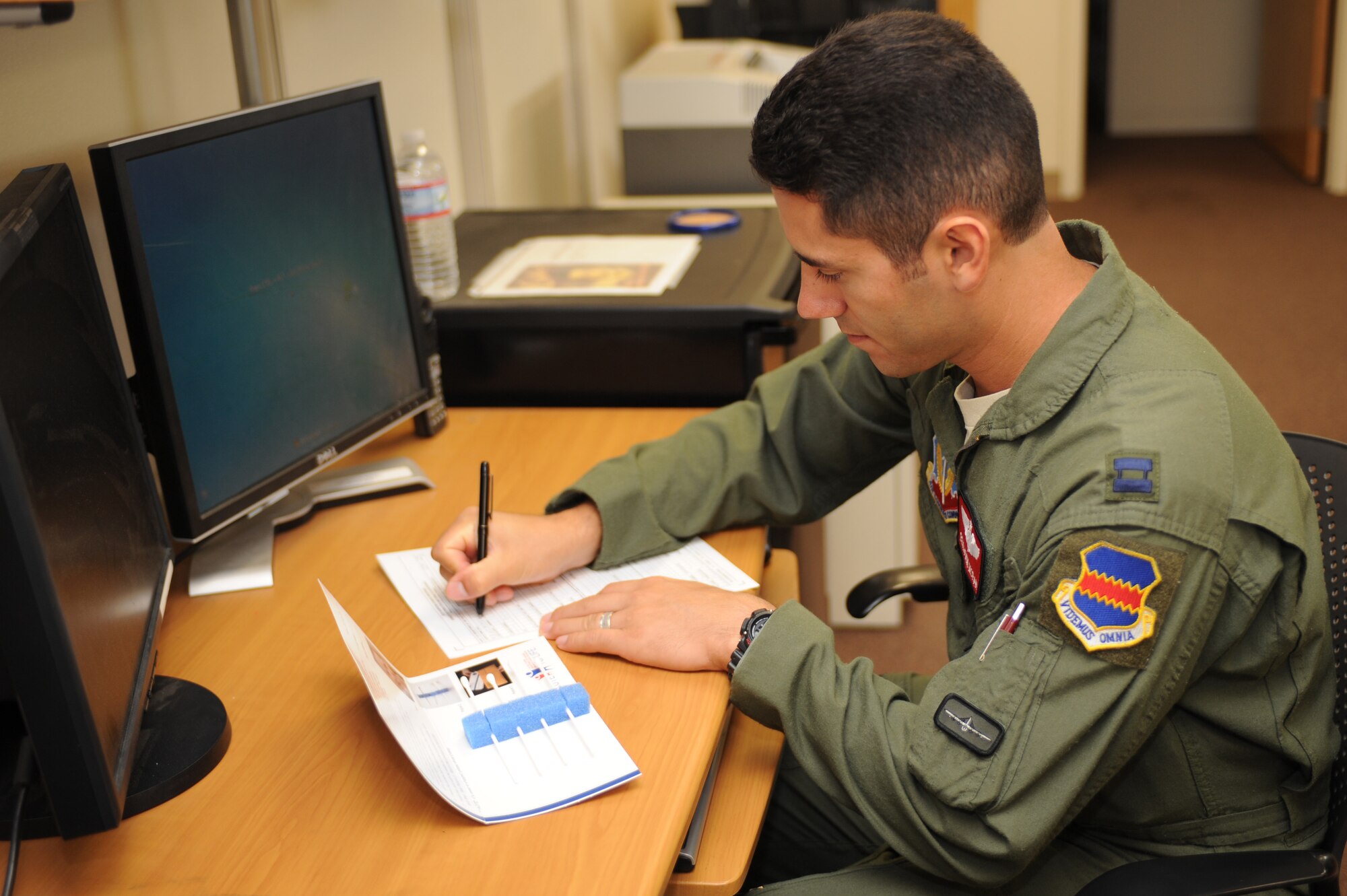 U.S. Air Force Capt. Benjamin Moran, 55th Electronic Combat Group deputy chief of standardization and evaluation, fills out a consent form at Davis-Monthan Air Force Base, Ariz., July 22 2014. The form is to register to donate bone morrow through the C.W. Bill Young Department of Defense Marrow Donor Program, also known as Salute to Life. Salute to Life works with military personnel as well as DoD civilian employees to facilitate marrow and stem donations. (U.S. Air Force photo by Airman 1st Class Cheyenne Morigeau/Released) 