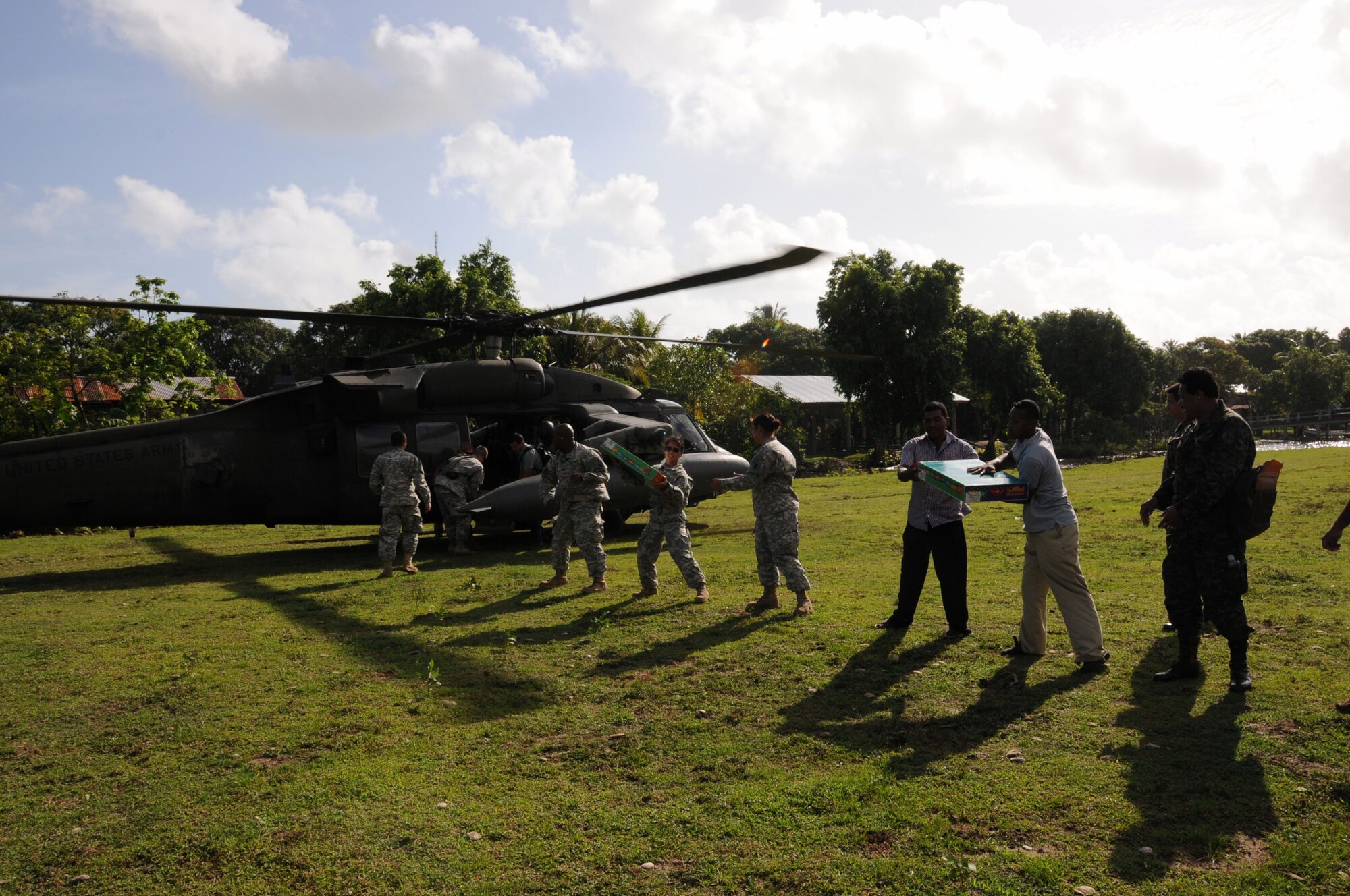 Members of Joint Task Force-Bravo, Honduras military and villagers from Barra Patuca,unload supplies from a UH-60 Black Hawk for a MEDRETE exercise.  Joint Task Force -Bravo's Medical Element (MEDEL), with support from 1-228th Aviation Regiment, JTF-Bravo Joint Security Forces and Army Forces Battalion, partnered with the Honduras Ministry of Health and the Honduran military to provide medical care to more than 650 people in the remote village of Barra Patuca in the Department of Gracias a Dios, Honduras, during a Medical Readiness Training Exercise (MEDRETE), July 17, 2014.  The multi-national team worked together to provide preventative medicine to the villagers, including classes on hygiene, preventative dental care, and nutrition. They also provided immunizations to infants, dental care, wellness checkups, medications, and minor medical procedures.  (Photo by U. S. Air National Guard Capt. Steven Stubbs)