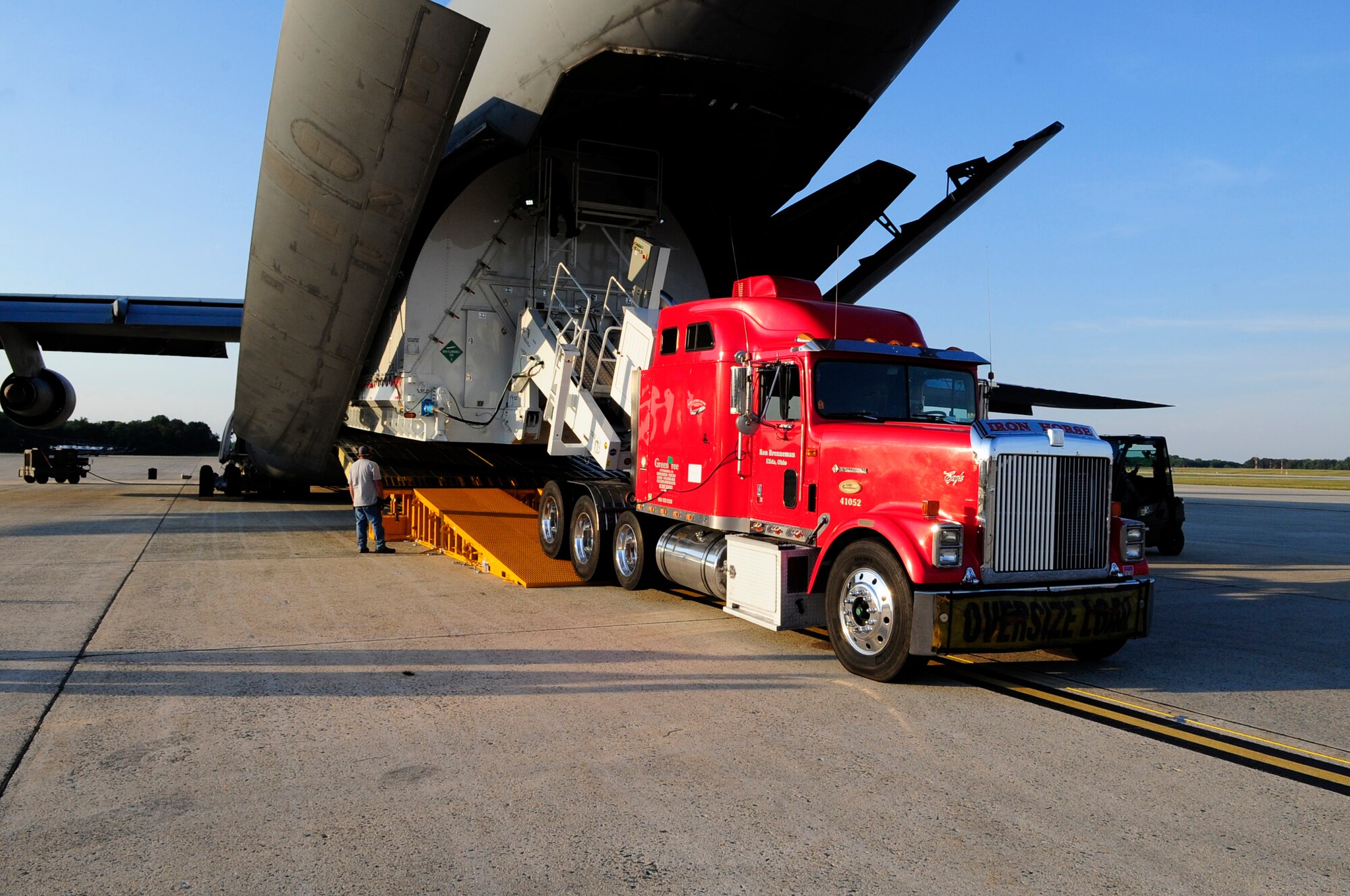 The Pathfinder slowly inches its way out from the C-5C Galaxy’s cargo hold at Joint Base Andrews, Md., July 17, 2014.  The crew used a winch to carefully squeeze the trailer through the Galaxy’s specially-modified rear doors. (U.S. Air Force photo/Staff Sgt. Torey Griffith)