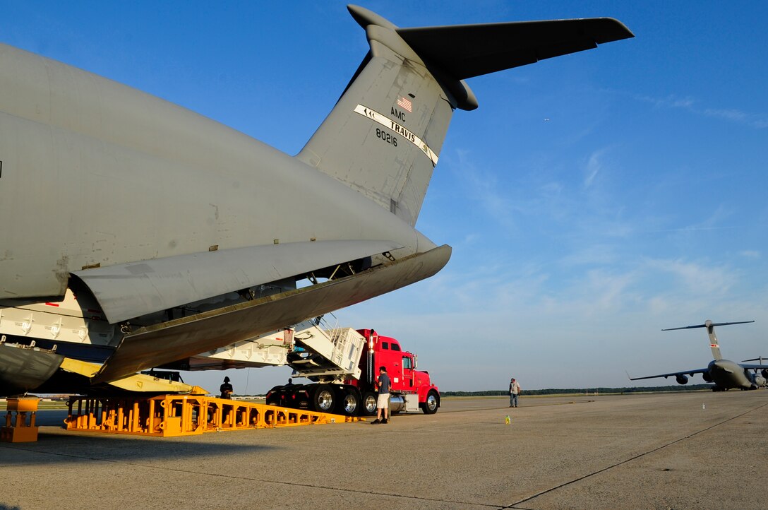 The Pathfinder slowly inches its way out from the C-5C Galaxy’s cargo hold at Joint Base Andrews, Md., July 17, 2014.  The crew used a winch to carefully squeeze the trailer through the Galaxy’s specially-modified rear doors. (U.S. Air Force photo/Staff Sgt. Torey Griffith)