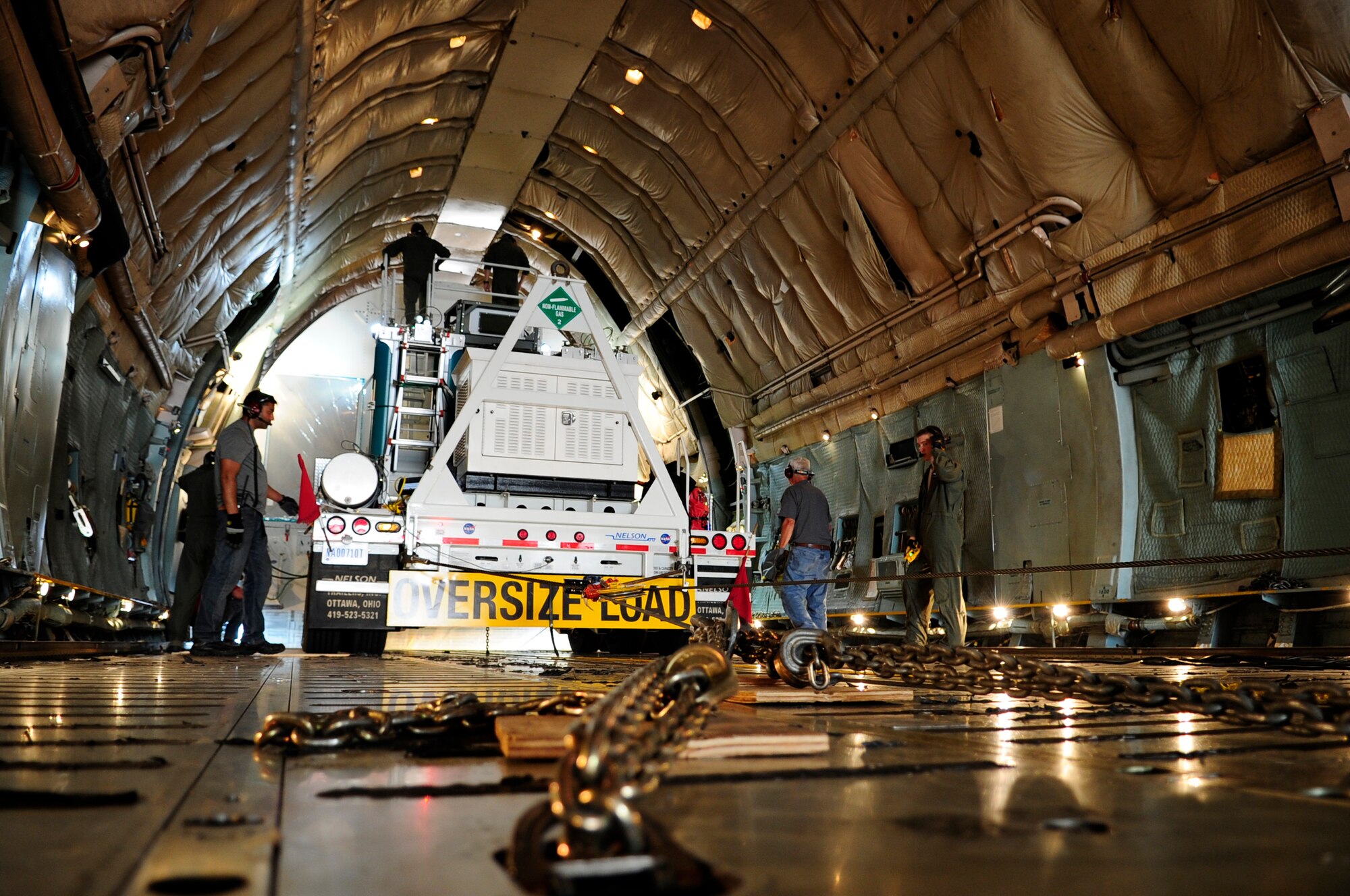 Crew members carefully ease the Pathfinder out of the C-5C Galaxy’s cargo area during the unloading process at Joint Base Andrews, Md., July 17, 2014.  This C-model Galaxy from the 22nd Airlift Squadron at Travis Air Force Base, Calif., is one of two “space cargo modified” planes in the Air Force fleet.  The planes were customized to carry satellites and large cargo, and routinely support the NASA mission by delivering assets throughout the nation. (U.S. Air Force photo/Staff Sgt. Torey Griffith)
